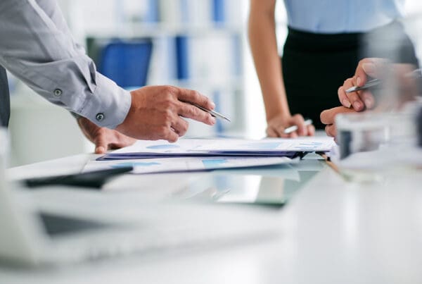 Insurance Premium Outlook for 2025 - Hands of Business People Working With Documents