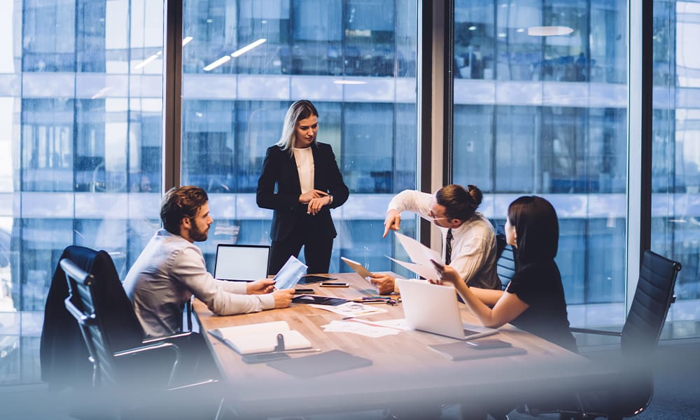 Protecting Your Future-Understanding Property and Casualty Insurance - Serious Female Entrepreneur Checking Wristwatch During Meeting in Office